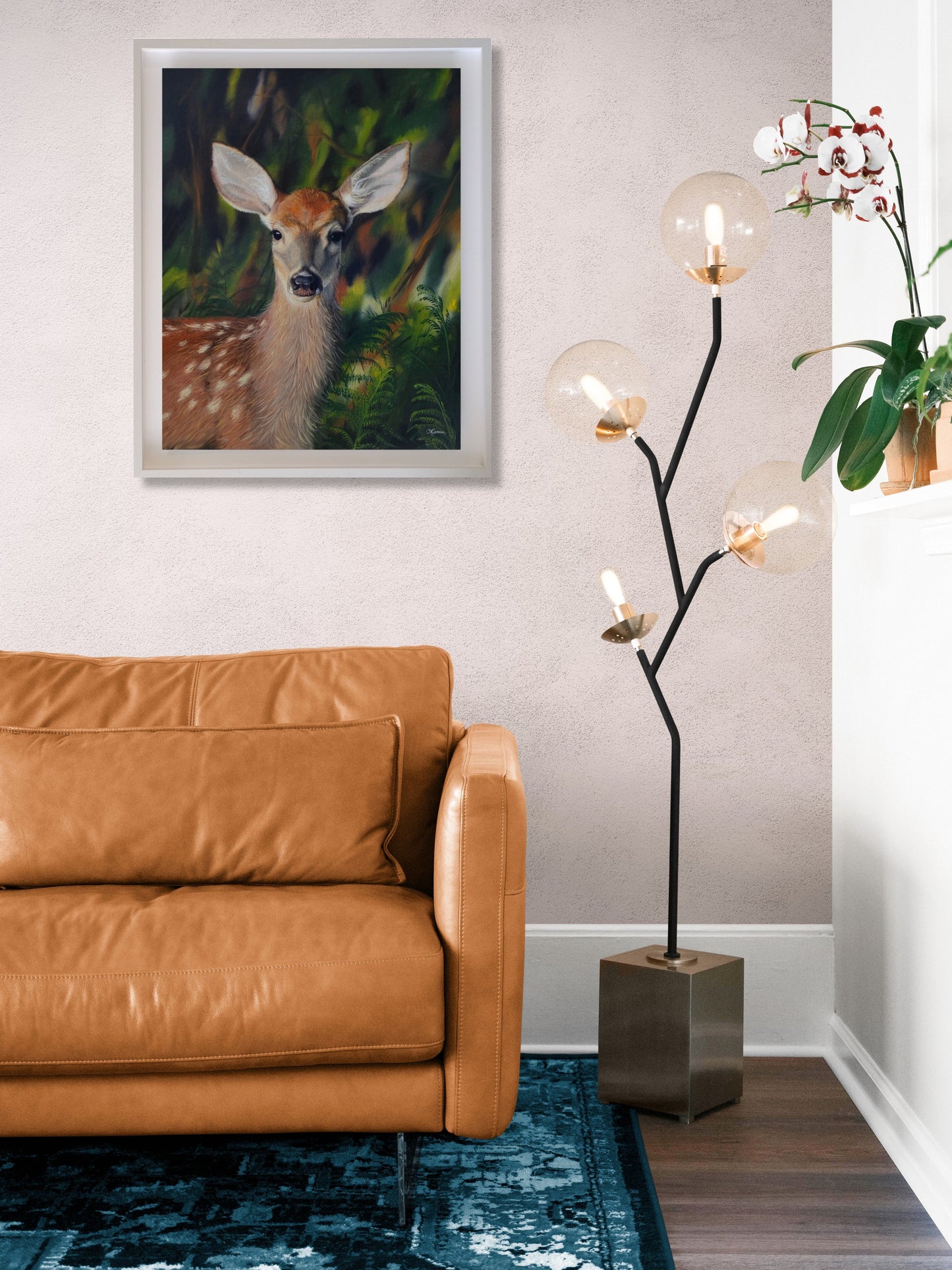 Calming oil painting of a fallow deer in a vibrant colour background. The painting is hanging on the wall of a modern living room