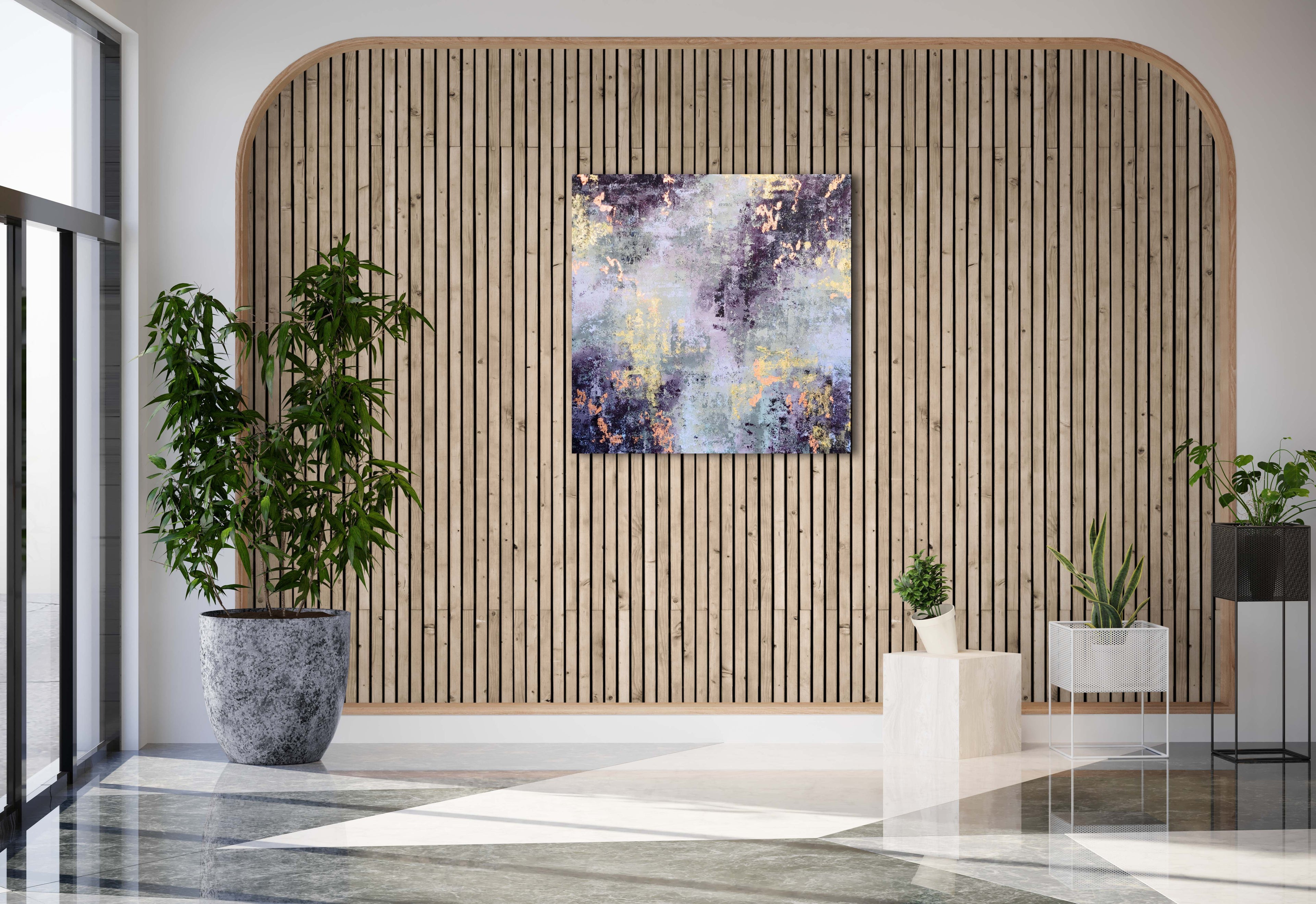 Abstract painting with gold and copper colours on the wall of a modern space