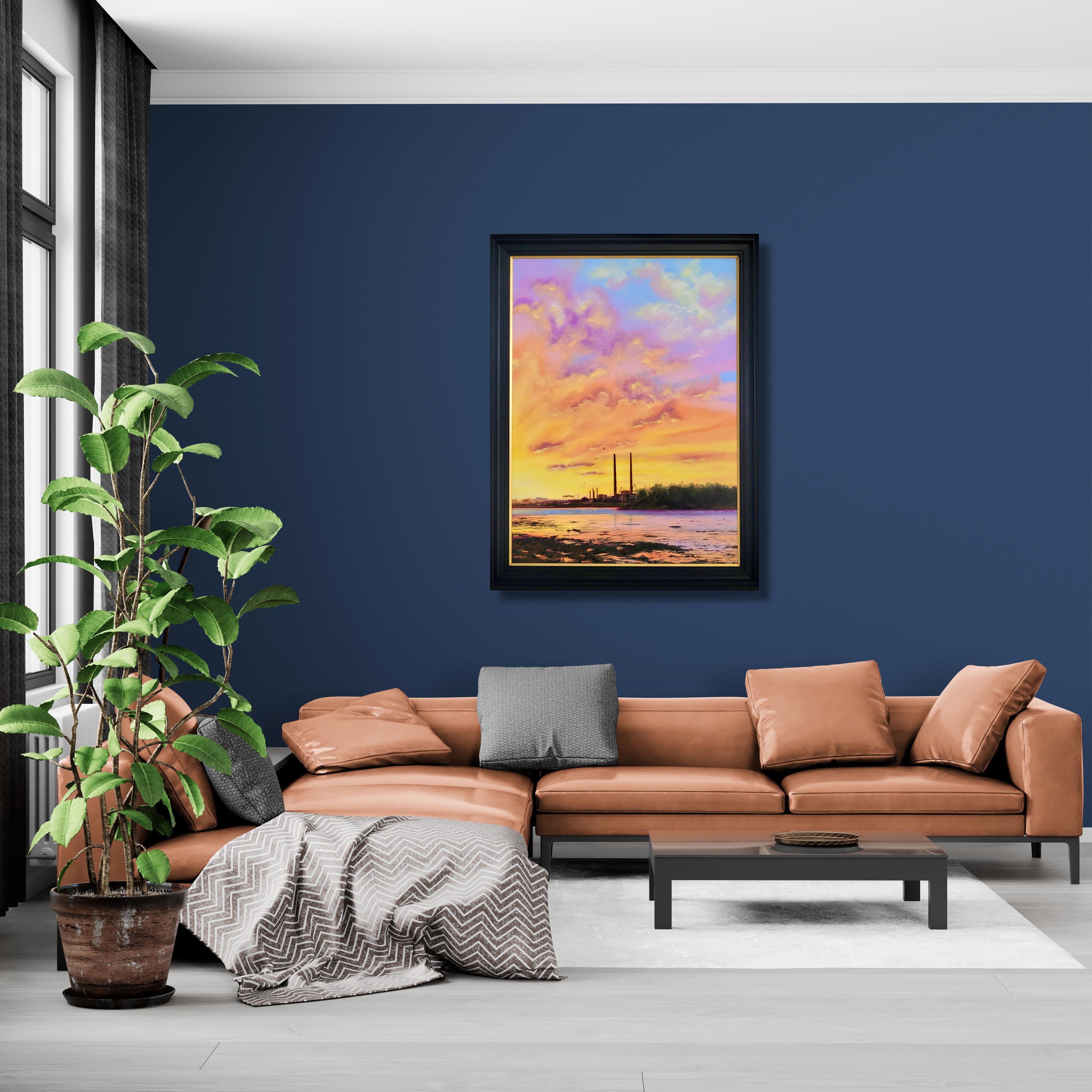 Modern living room with a brown sectional sofa, plant, and framed artwork on a blue wall.