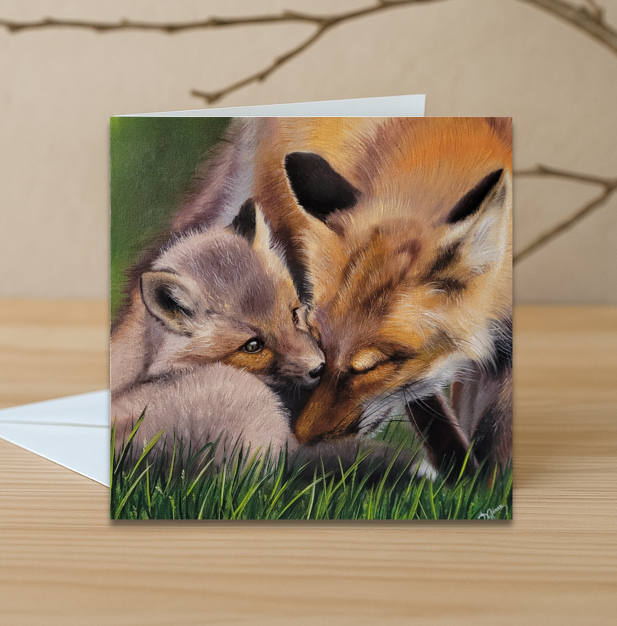 Greeting card with illustration of mom fox and her kit embracing on a grassy background