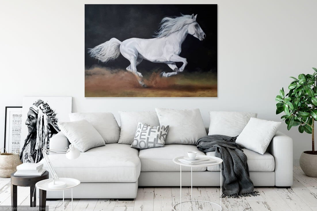 Freedom is a painting of a white horse running free. The painting is hanging on the walls of a modern living room in light colours