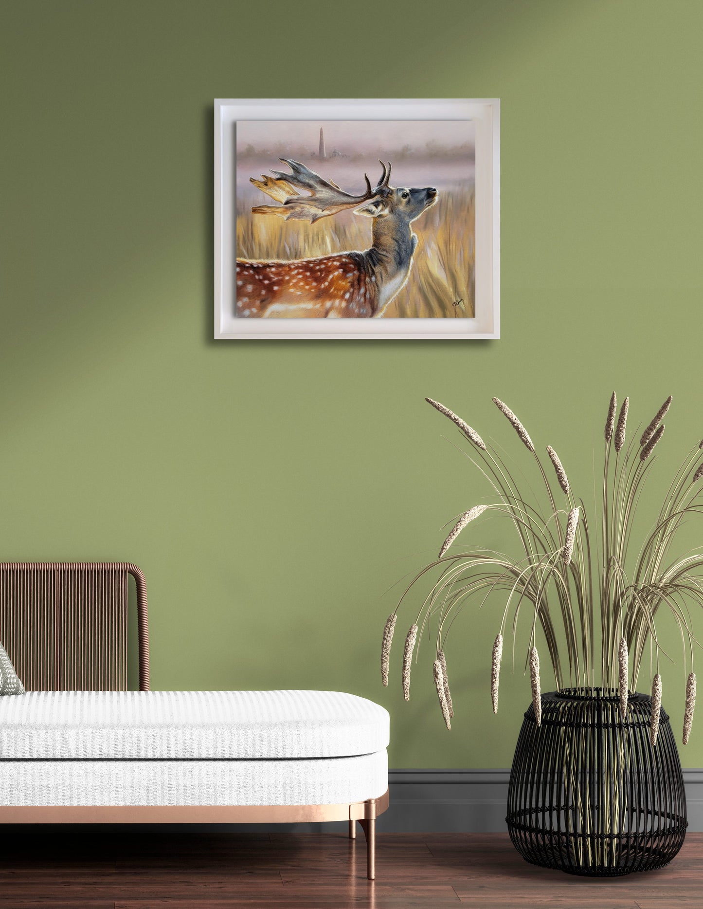 framed deer painting on a green modern wall